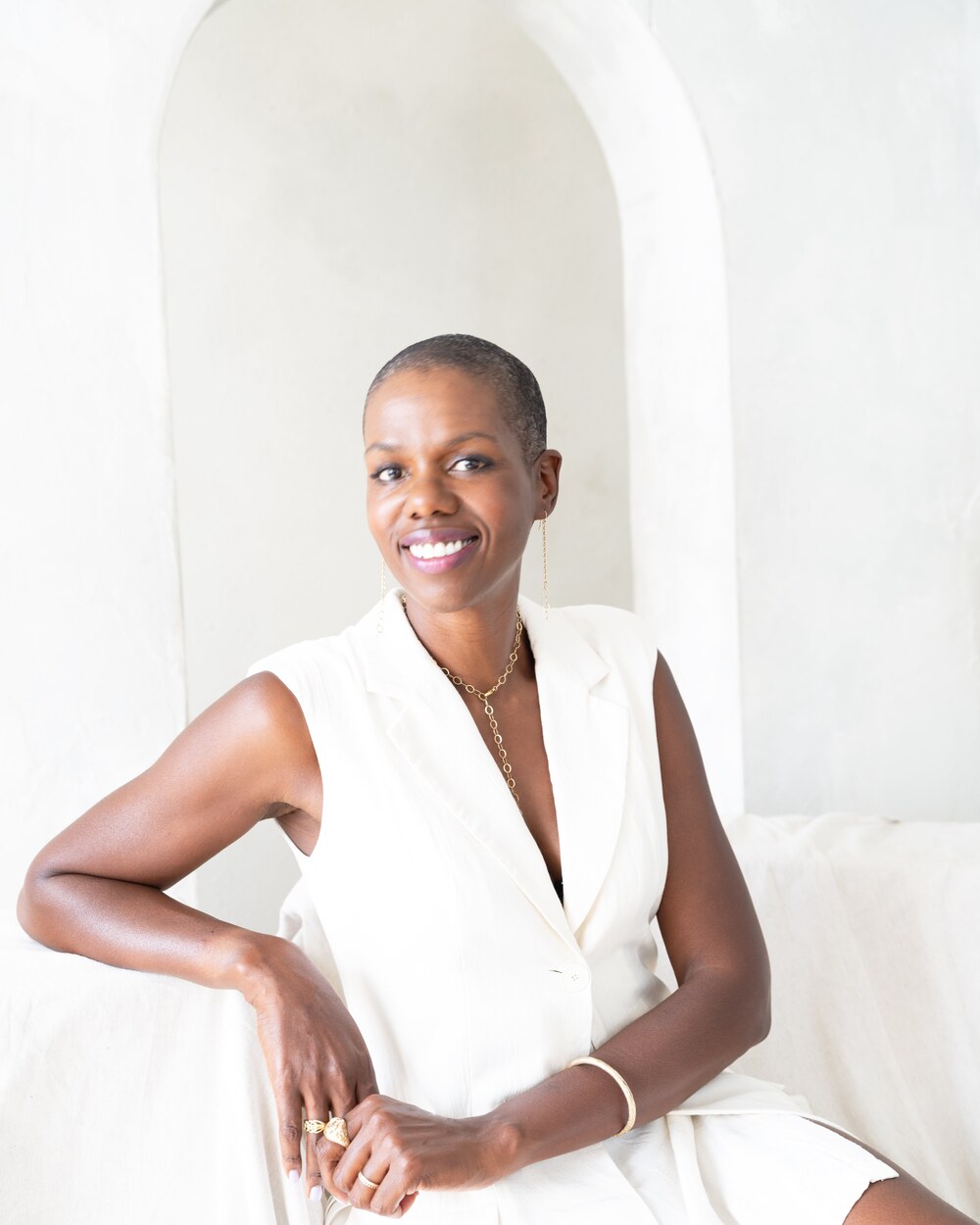 Francesca Hogi seated in a plaster archway, photographed by Grace Bukunmi